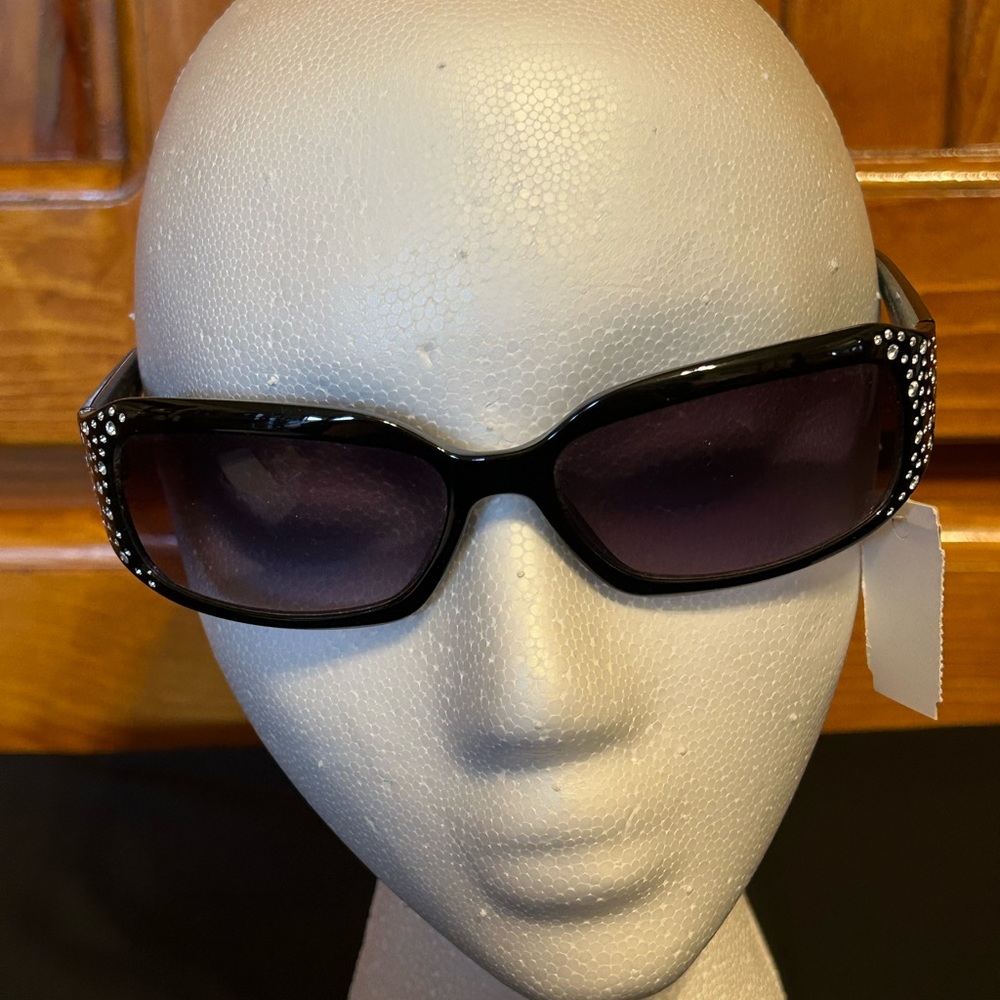 Black acrylic rhinestone at temple sides. New